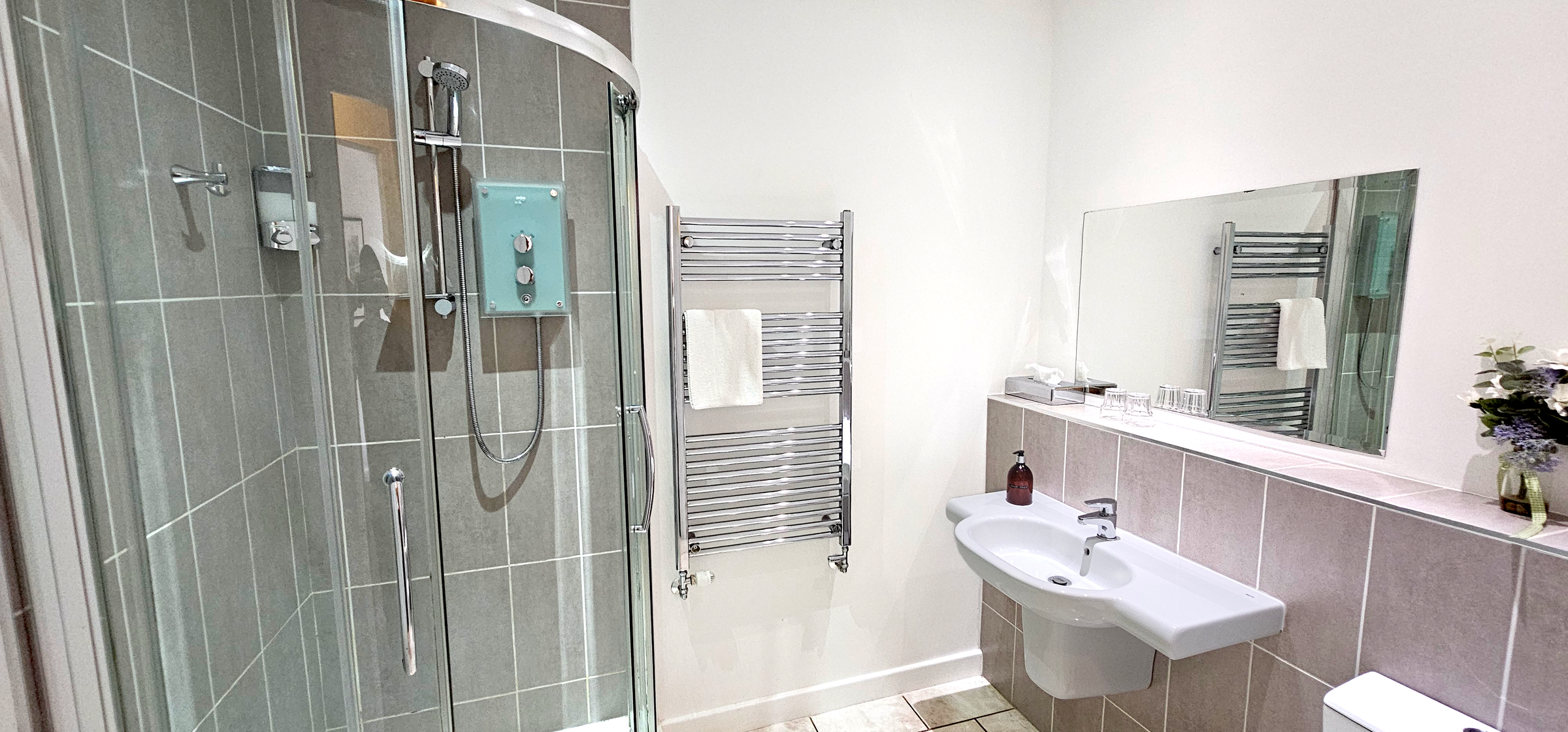 Large bathroom with with corner shower