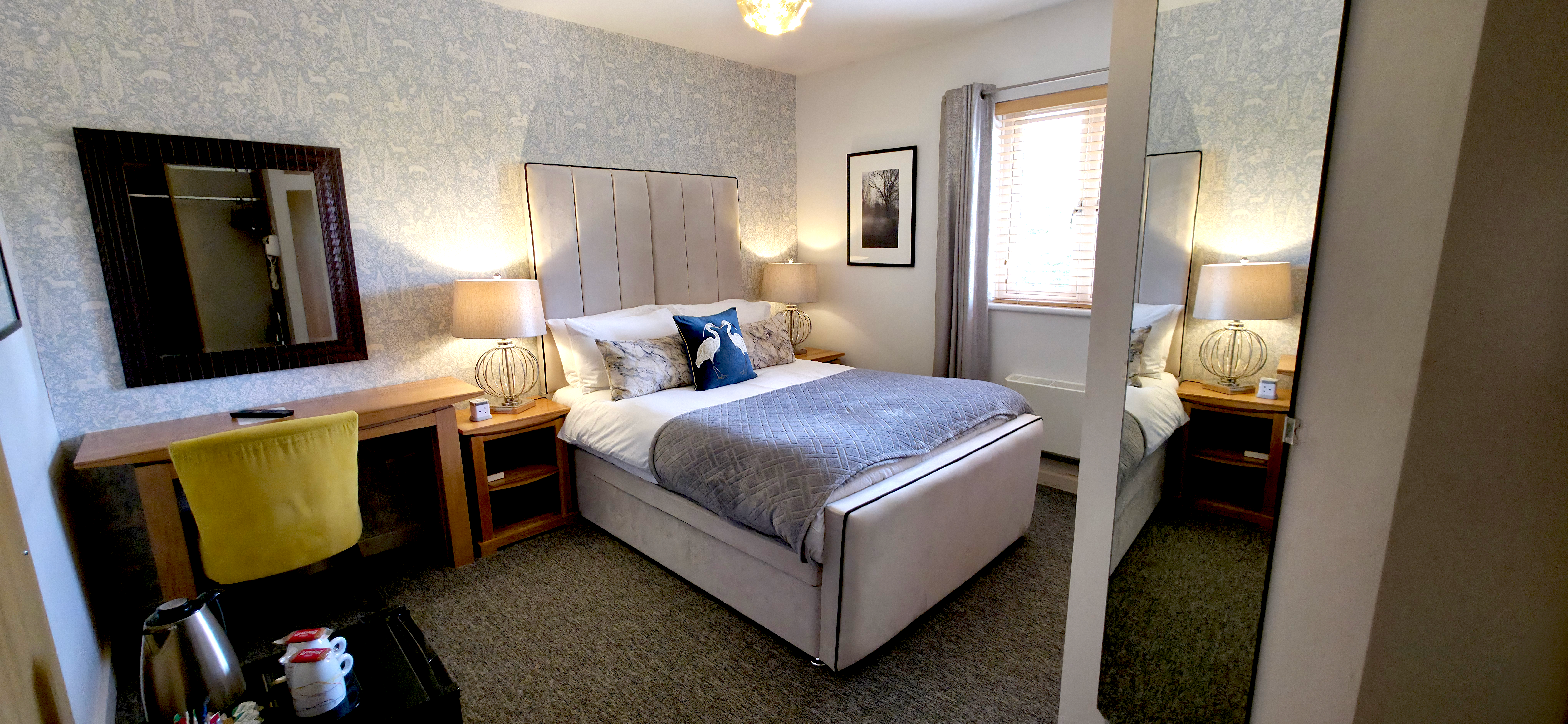 Double bed with panelled headboard, desk, tea & coffee station & mirror