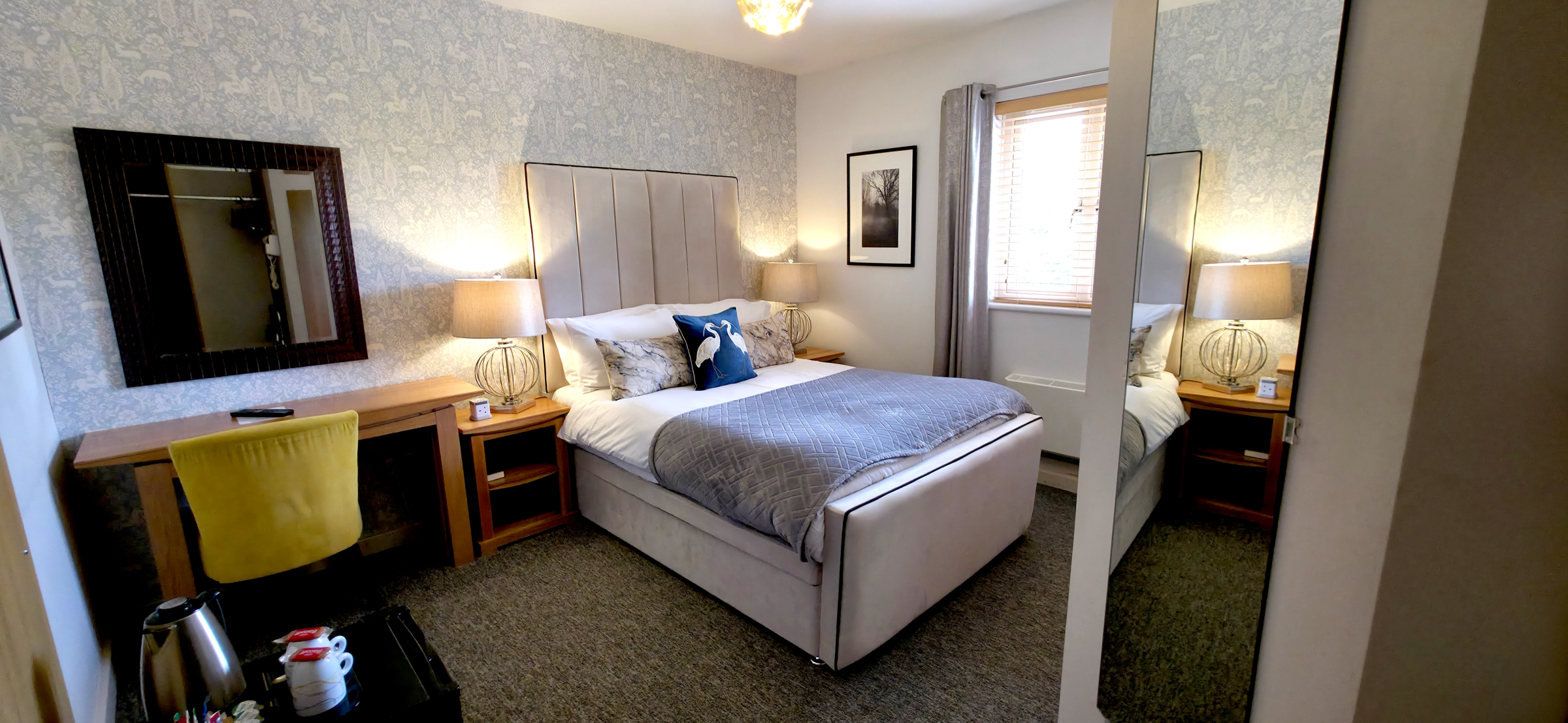 Double bed with panelled headboard, desk, tea & coffee station & mirror