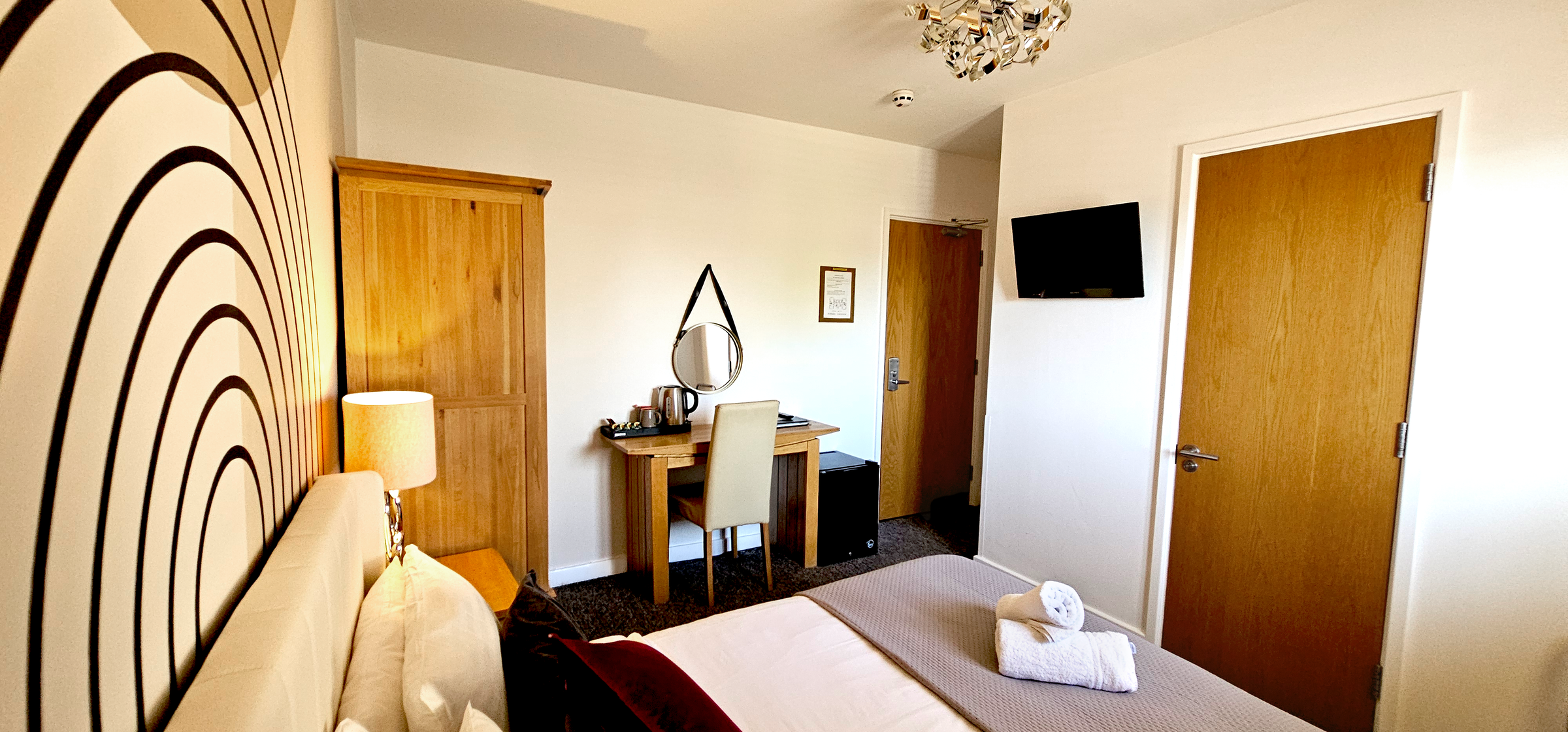 Double room with hardwood wardrobe, digital TV, hanging mirror & door to ensuite bathroom