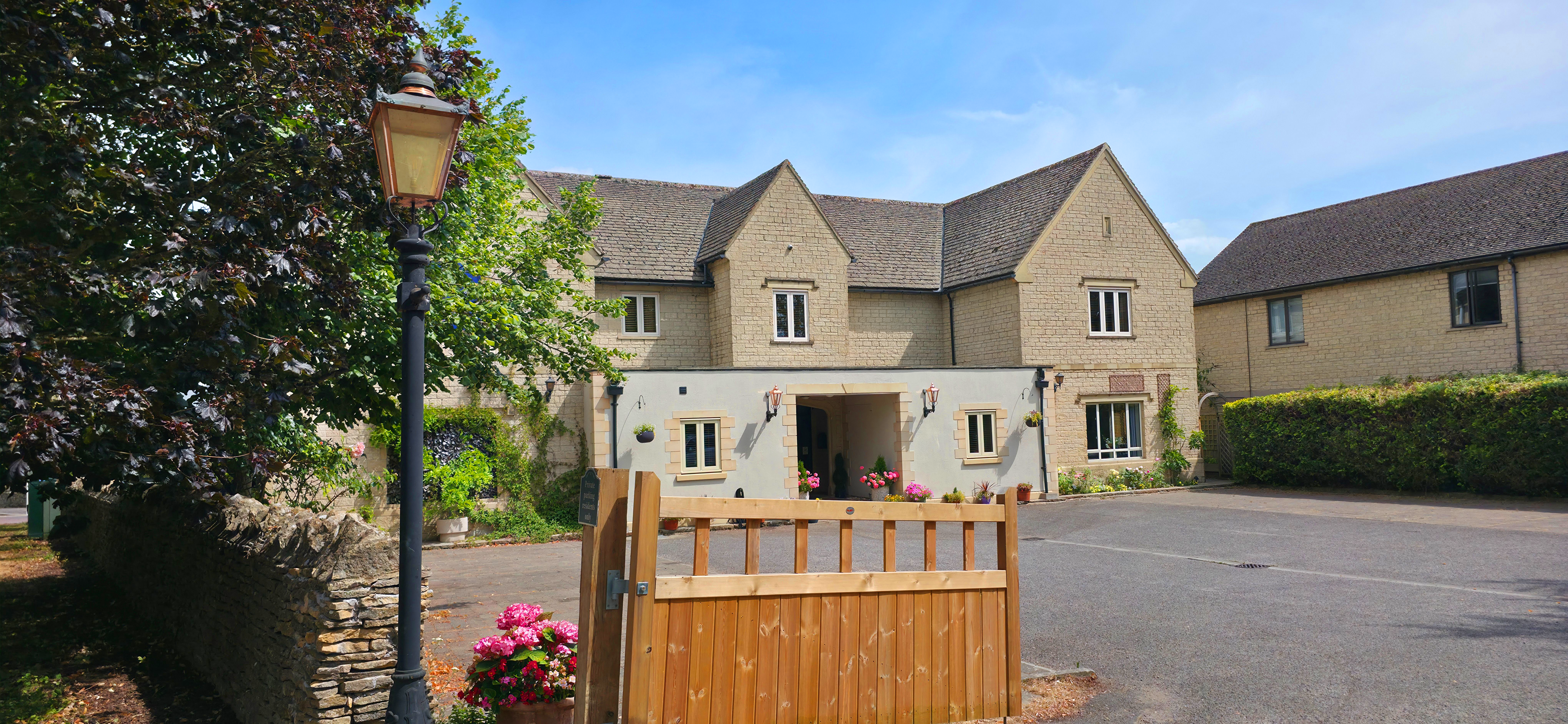The Churchill Court Boutique House with wooden gate in front & Victorian gas lamp
