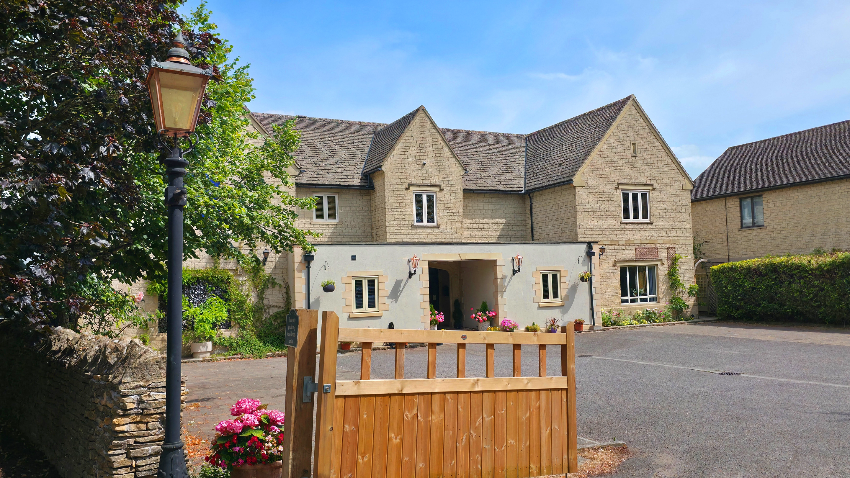 The Churchill Court Boutique House with wooden gate in front & Victorian gas lamp