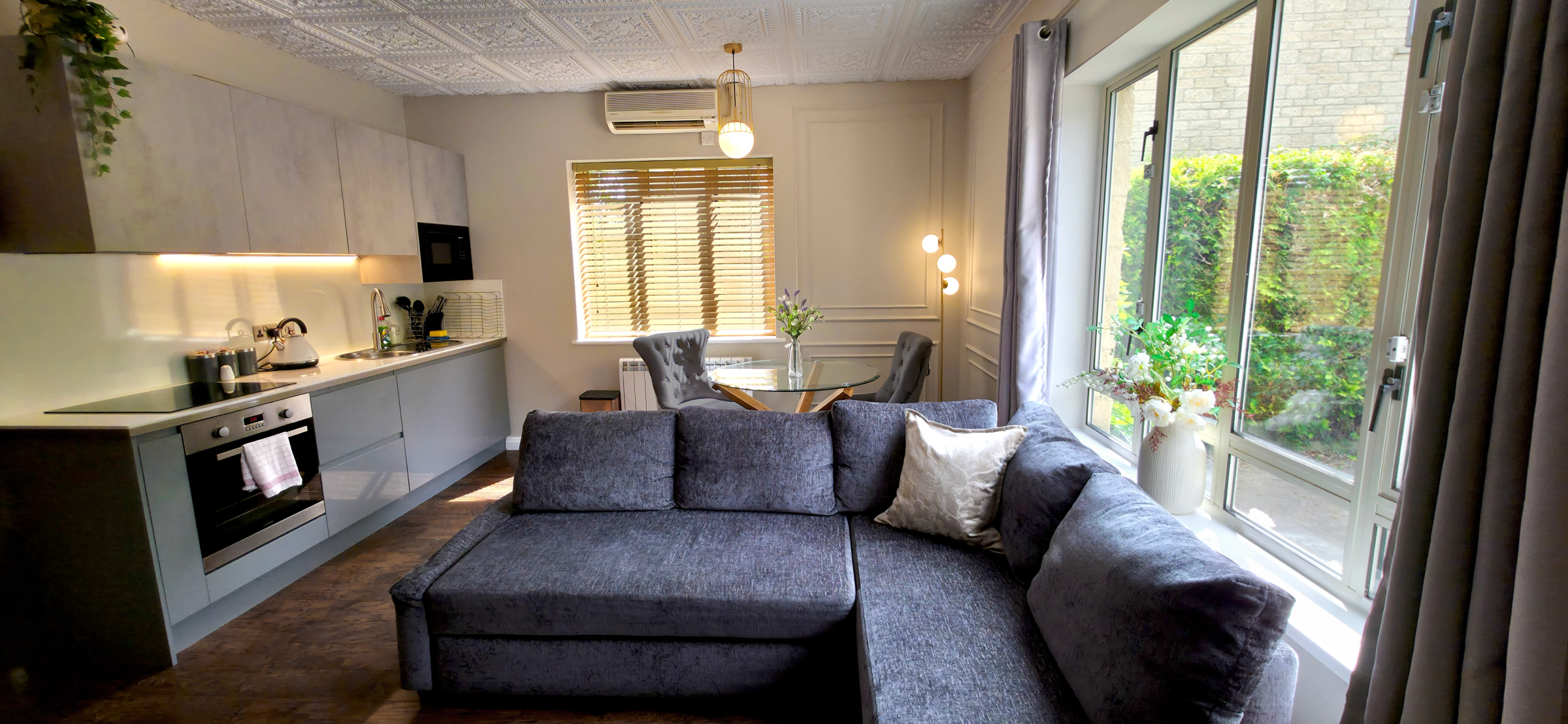 Grey corner sofa with dining table & full kitchenette with oven, hobs & microwave 