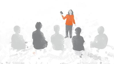 Image showing a person in an orange coat speaking to participants during beach cleaning.