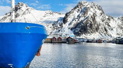 Vessel with a blue hull at the port of Svolvær.