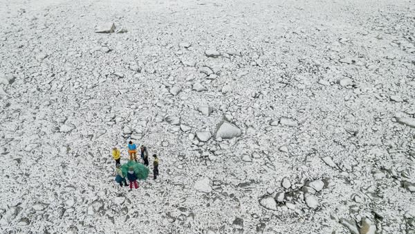 Stone beach with marine litter. The picture is taken towards the horizon.