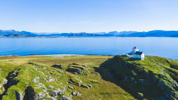 Island with a lighthouse, surrounded by sea. Erkna in Sunnmøre.