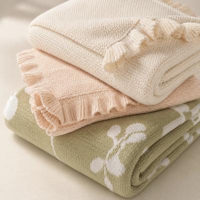 Folded cotton knit baby blankets with textured patterns