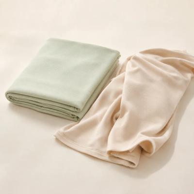Folded bamboo swaddle blankets in soft neutral colors