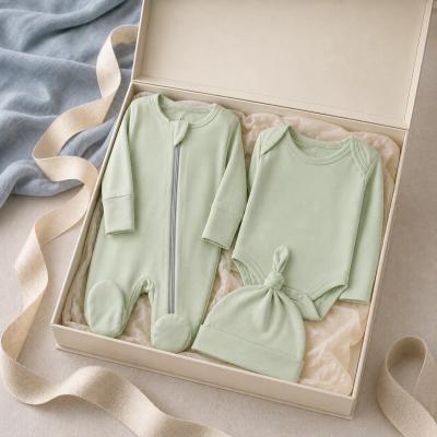 Baby gift set with bodysuit, zip footie pajama, and knotted cap