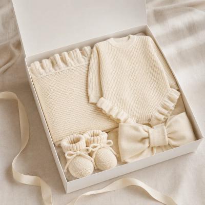 Baby shower gift set with blanket and newborn essentials