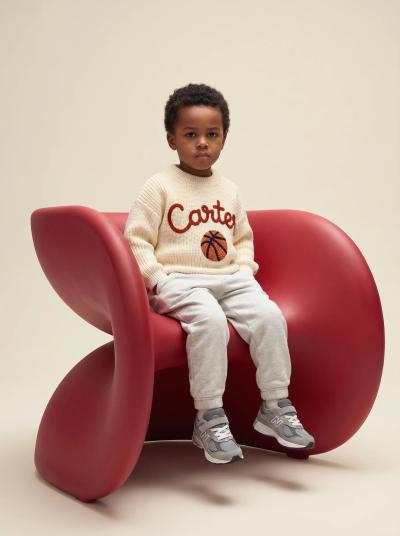 Baby wearing a sweater with embroidered name