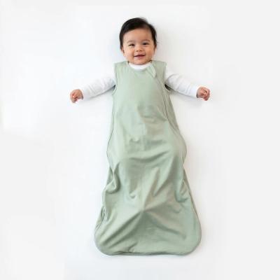 Baby wearing a sage bamboo sleep sack