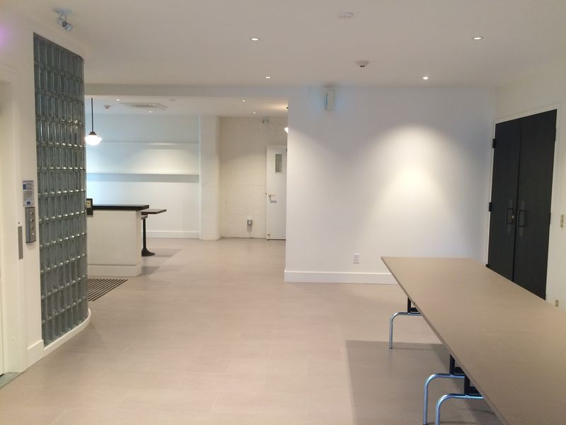 The lobby beside the glass-block wall, looking towards the hall doors