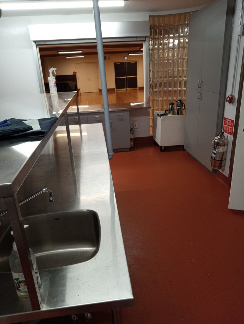 The kitchen's stainless counter and handwashing sink