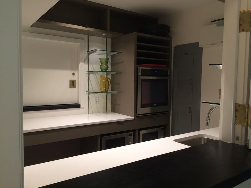 The servery counter, oven and microwaves along the back wall