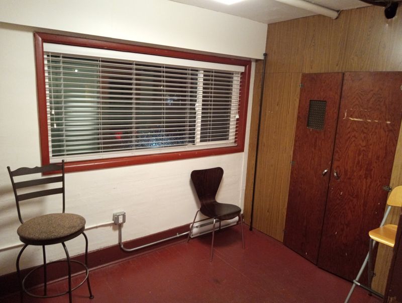 A dressing room with chairs beside the window