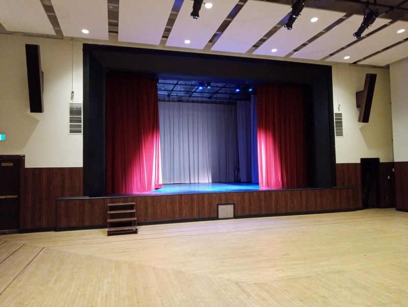 The Upstairs Hall stage lit in pink and blue