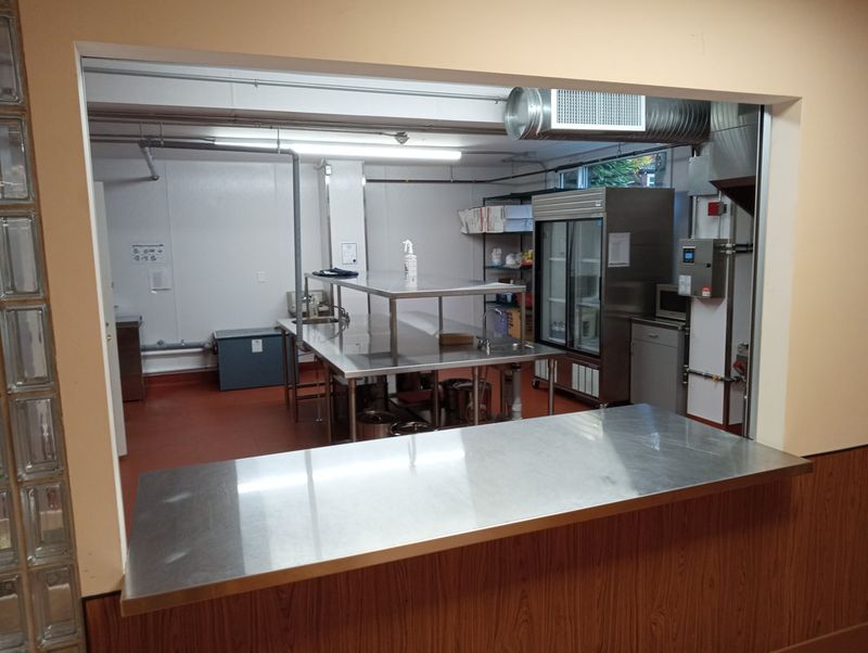 The kitchen seen through its serving window to the Downstairs Hall