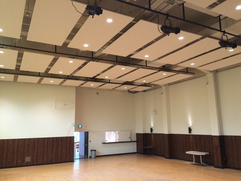 The Upstairs Hall floor and wood panelling, lit by the windows at the far end