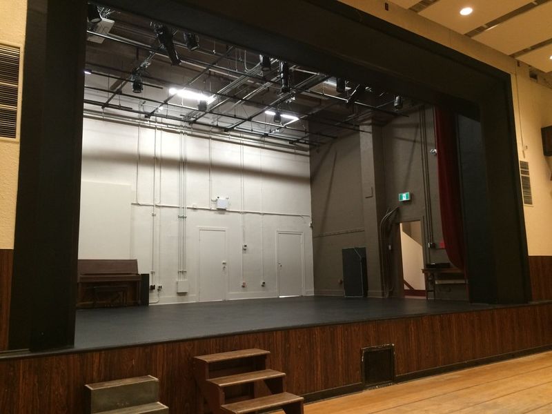 The Upstairs Hall stage, curtains open onto the bare back wall