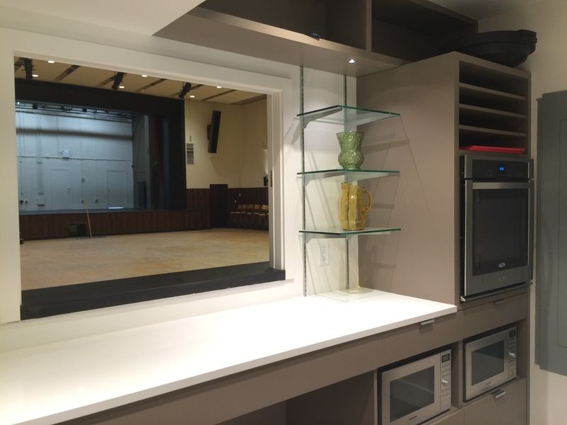 The servery window looking through to the Upstairs Hall stage
