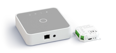 Two white Parqio hardware devices — a square smart-access hub with Wi-Fi and power indicators and an Ethernet port, alongside a compact relay/controller module with green terminal blocks and a USB port — displayed against a black background.