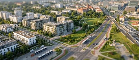 Aerial tilt-shift photograph of a modern residential neighbourhood with multi-storey apartment blocks, green parkland, and a wide multi-lane urban road with buses and cars.