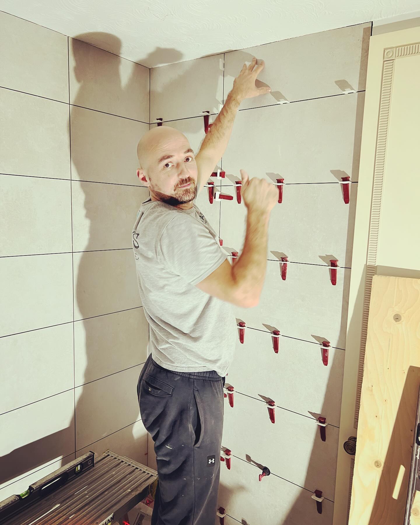 Seb Kirk working on tiling a wall