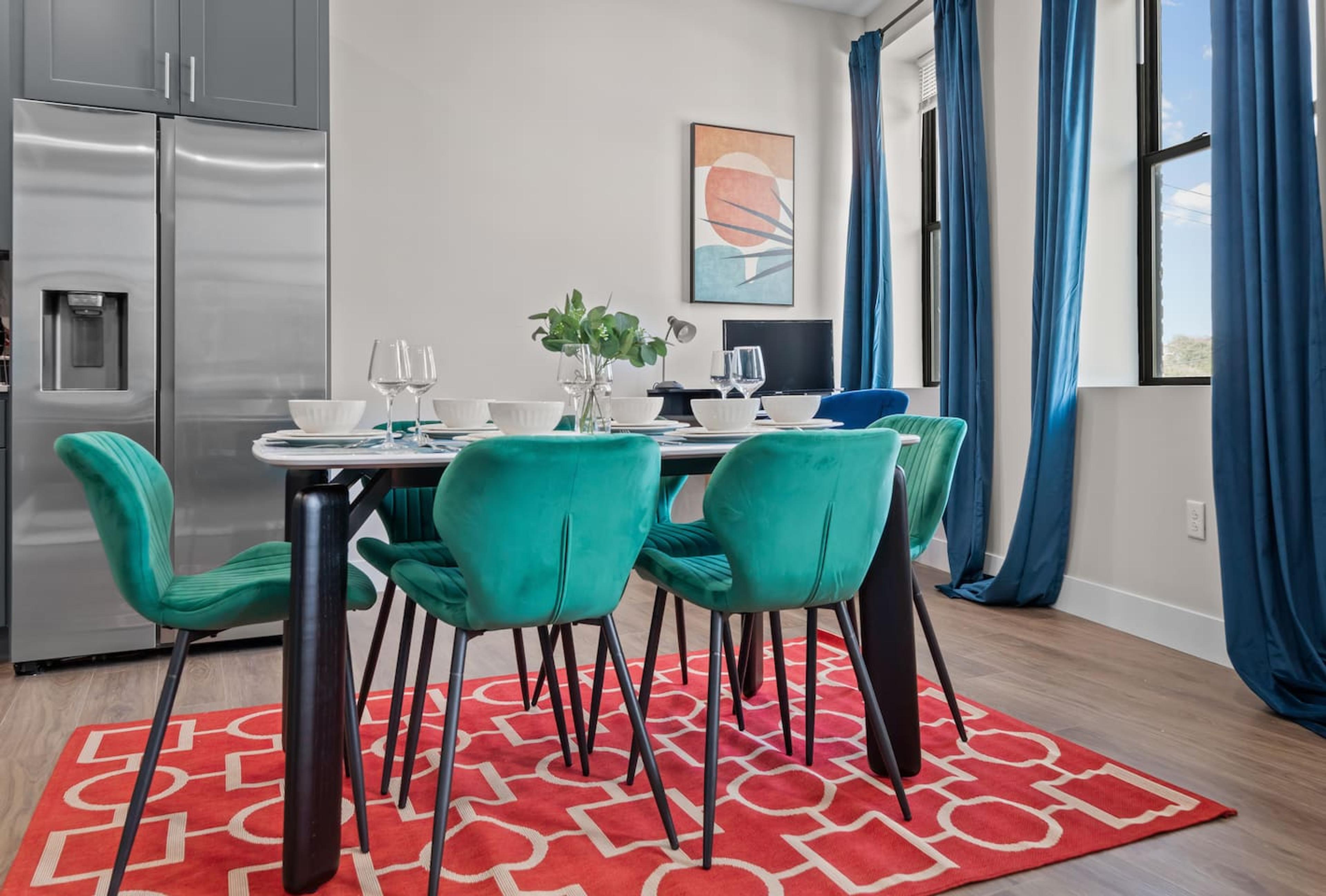 This dining room is perfect for entertaining. It has a large table that can seat six people comfortably.