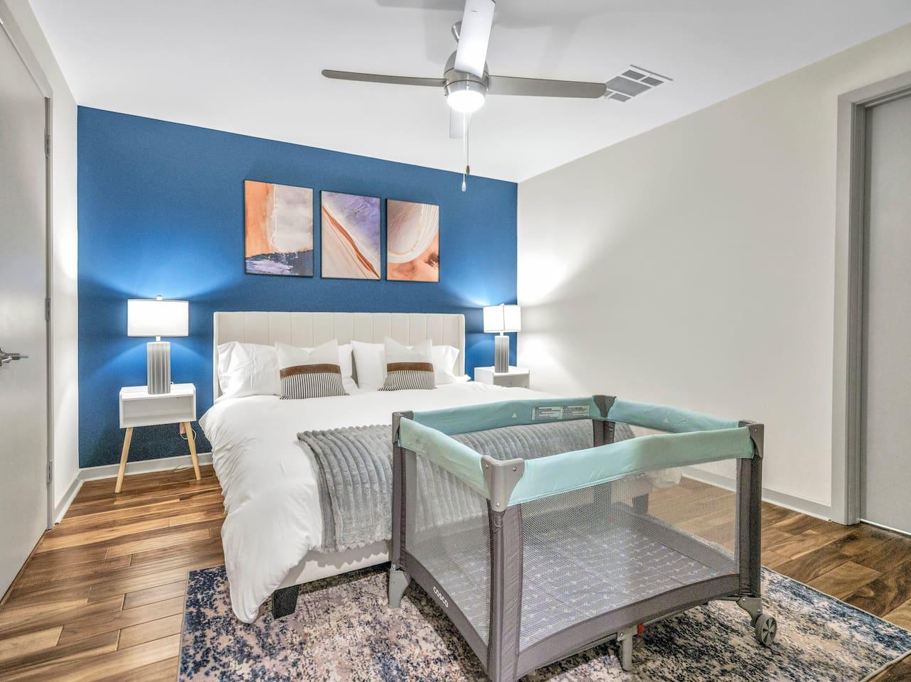A Perfect cute spacious bedroom with one king bed that sleeps 2 adults. Designed with with comfort in mind and equipped with memory foam mattress, Cozy bedroom with nightstands, Pack N Play