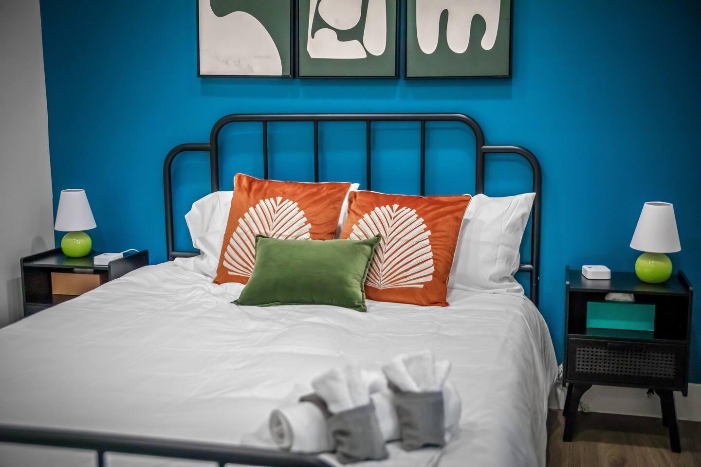 Bedroom 1 : Queen size bed with comfy mattress and two side table with night lamps and charging station on each.