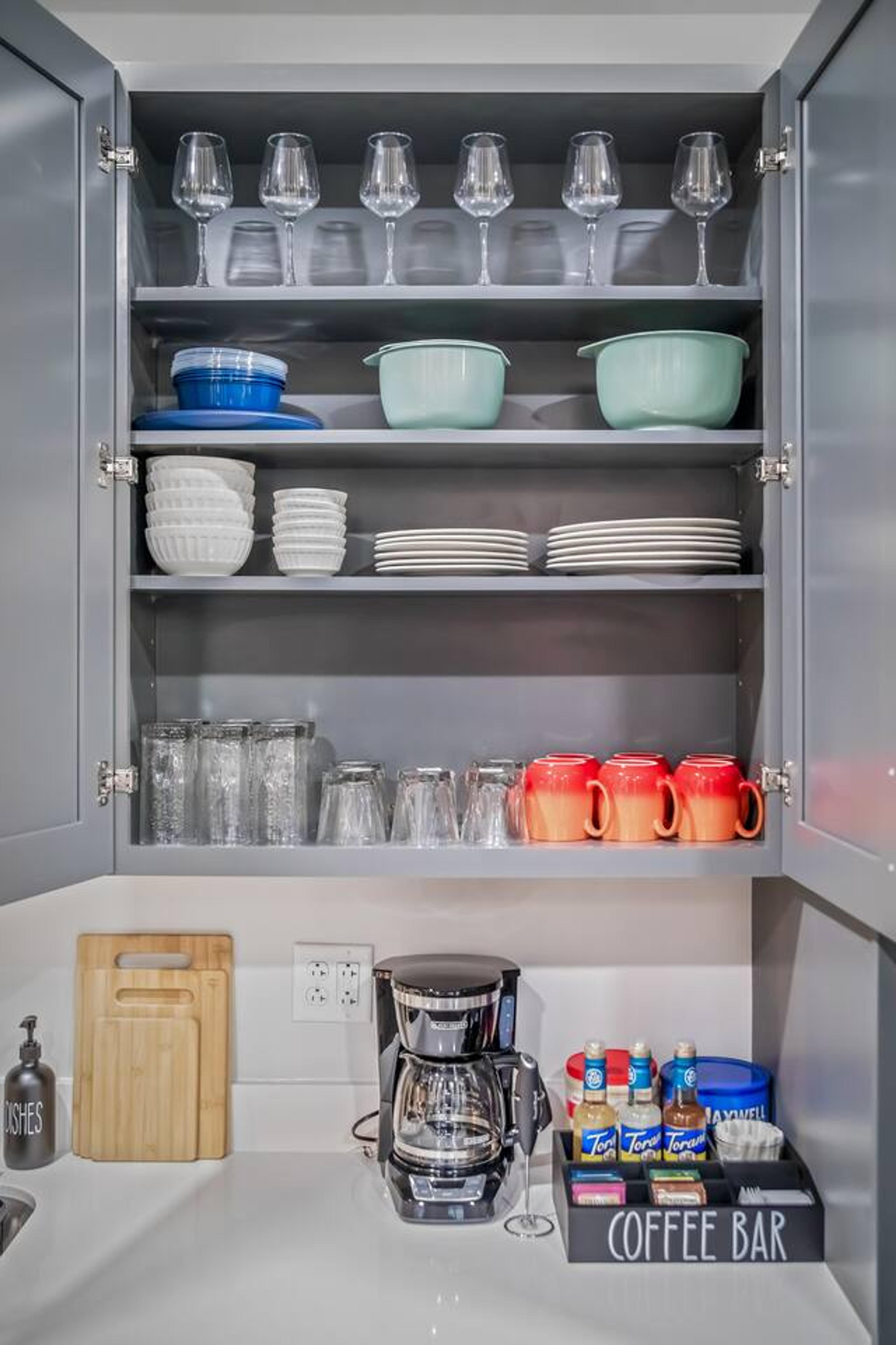 Kitchen with : Knife set , cutting board, hand & dish soap, blender, coffee station with coffee and tea flavours, pots , pans, cups, mugs, glasses  and dinning set !