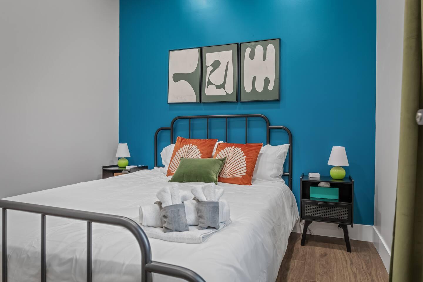 This bedroom has a queen-size bed. It's a comfortable room with an aesthetic look