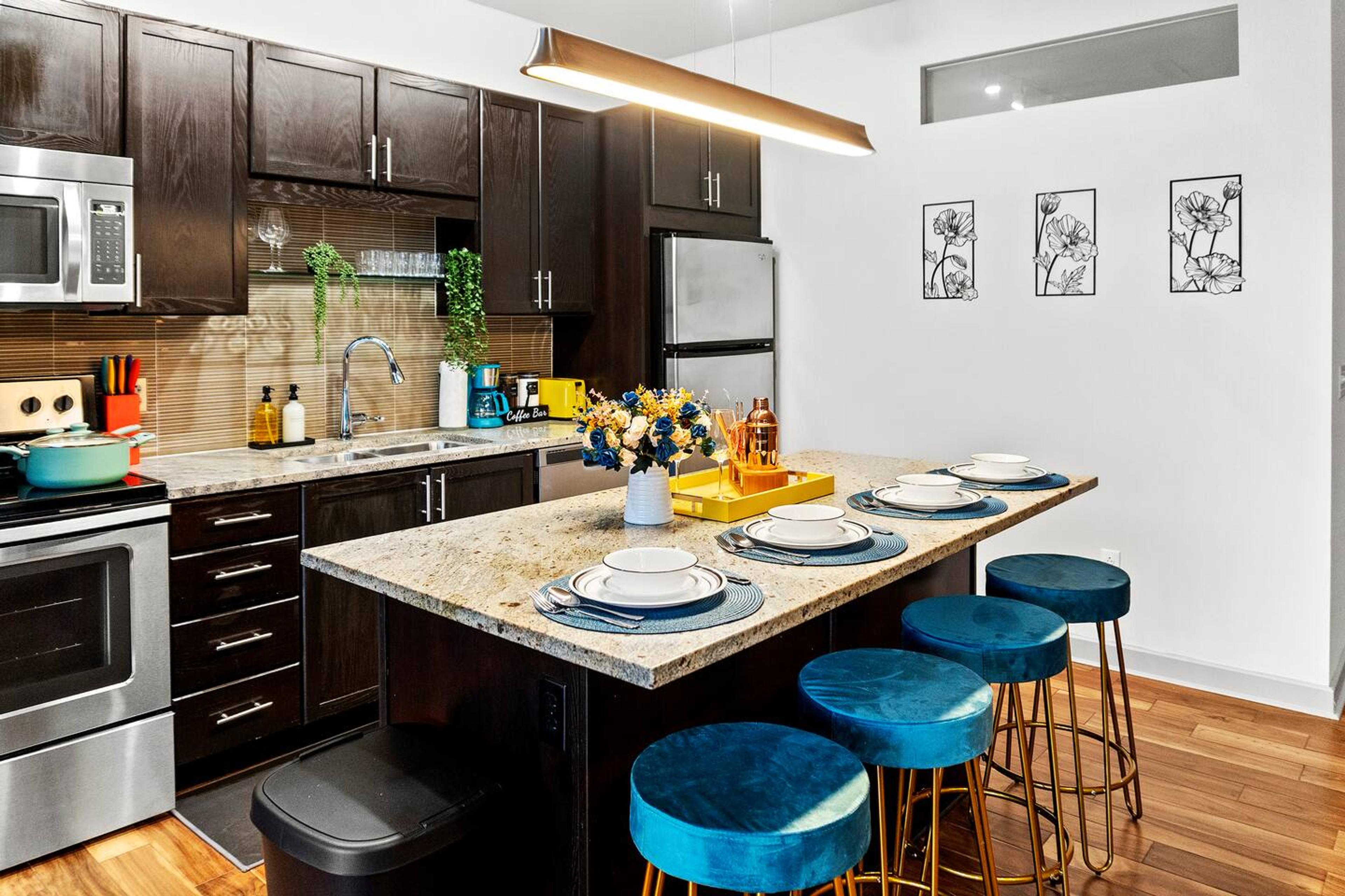 Kitchen with stainless steel appliance. Equipped with utensils and basic needs for short and mid term stay with a dining space to enjoy your cooking time with your loved ones!