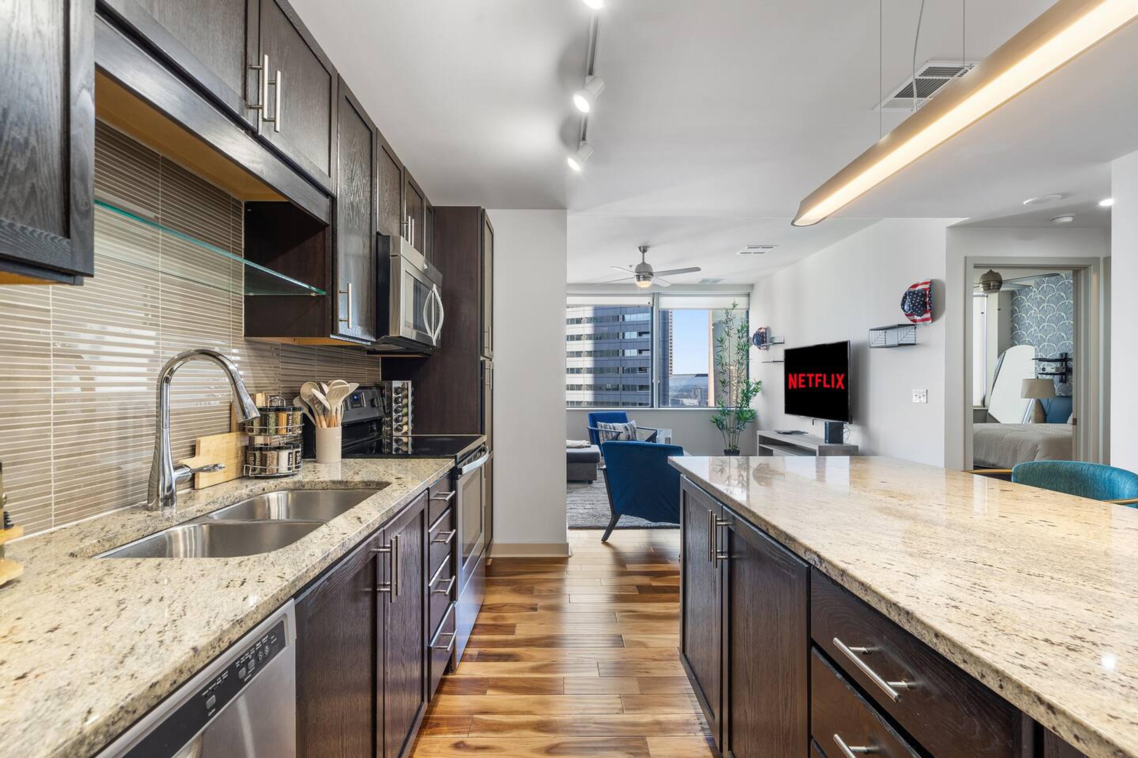 Kitchen with stainless steel appliance. Equipped with utensils and basic needs for short and mid term stay.