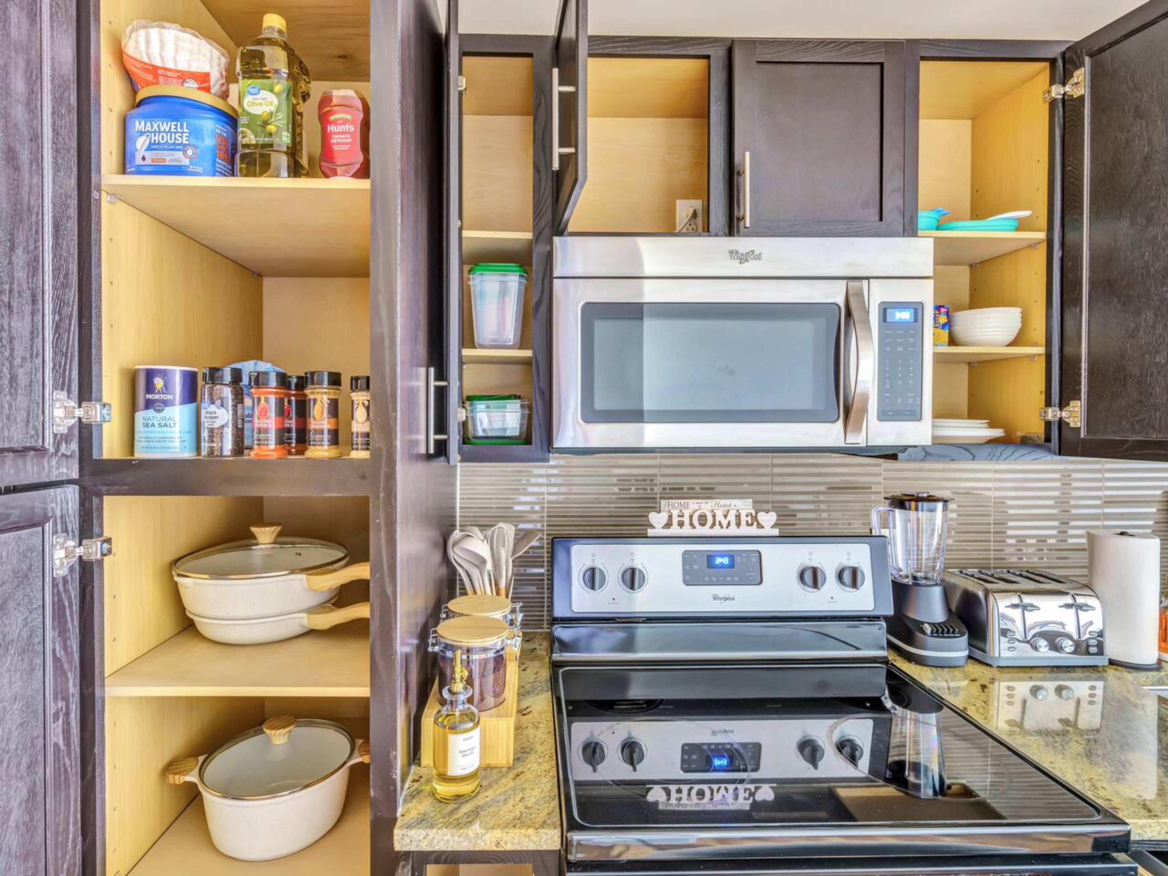 Fully equipped Kitchen: Kettle, knife set, coffee maker, cutting board, blender, electric stove, microwave, oven, spatulas, whiskers, toaster, stainless steel appliances ,pots, pans, spice cabinet.