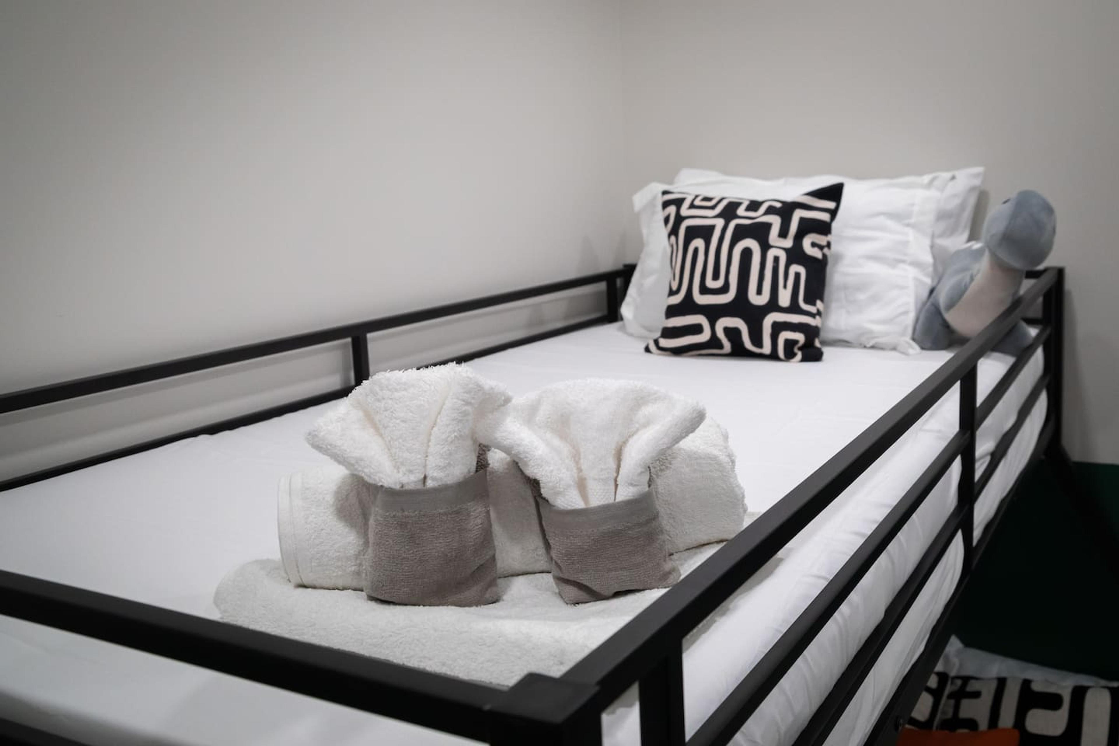 Clean beds with fresh blankets for the bunk bed.