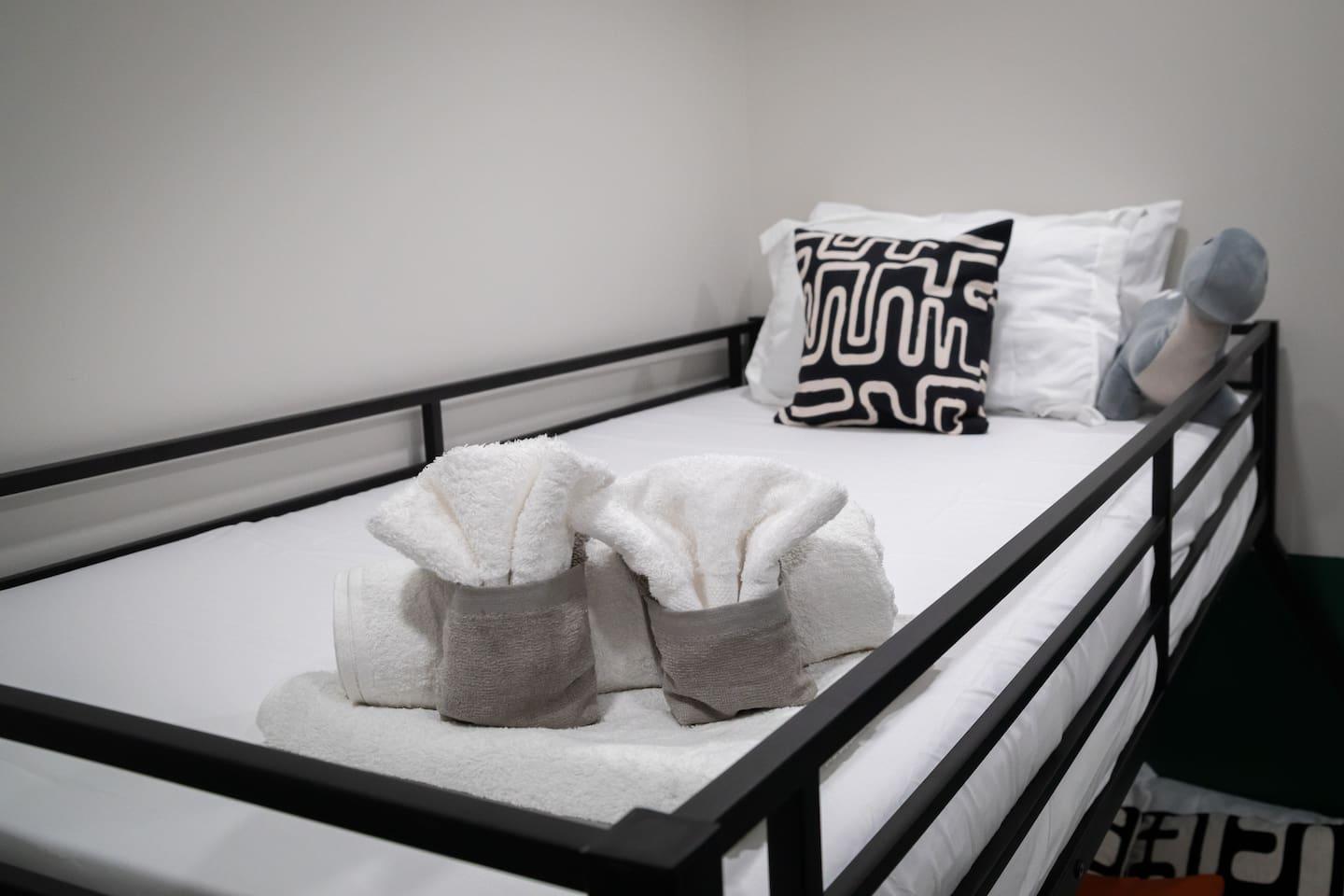 Clean beds with fresh blankets for the bunk bed.