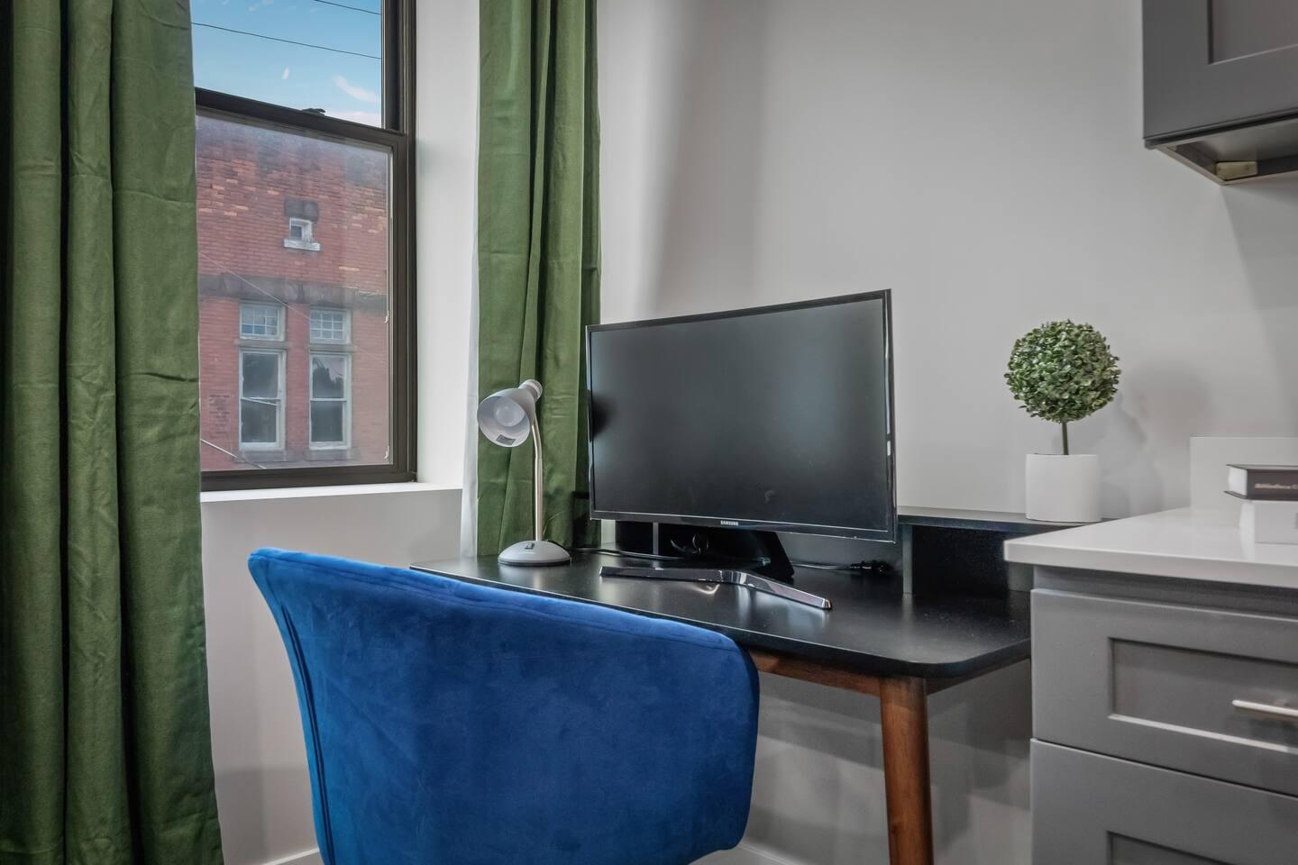 A workspace equipped with a table, chair, and monitor (By Request).