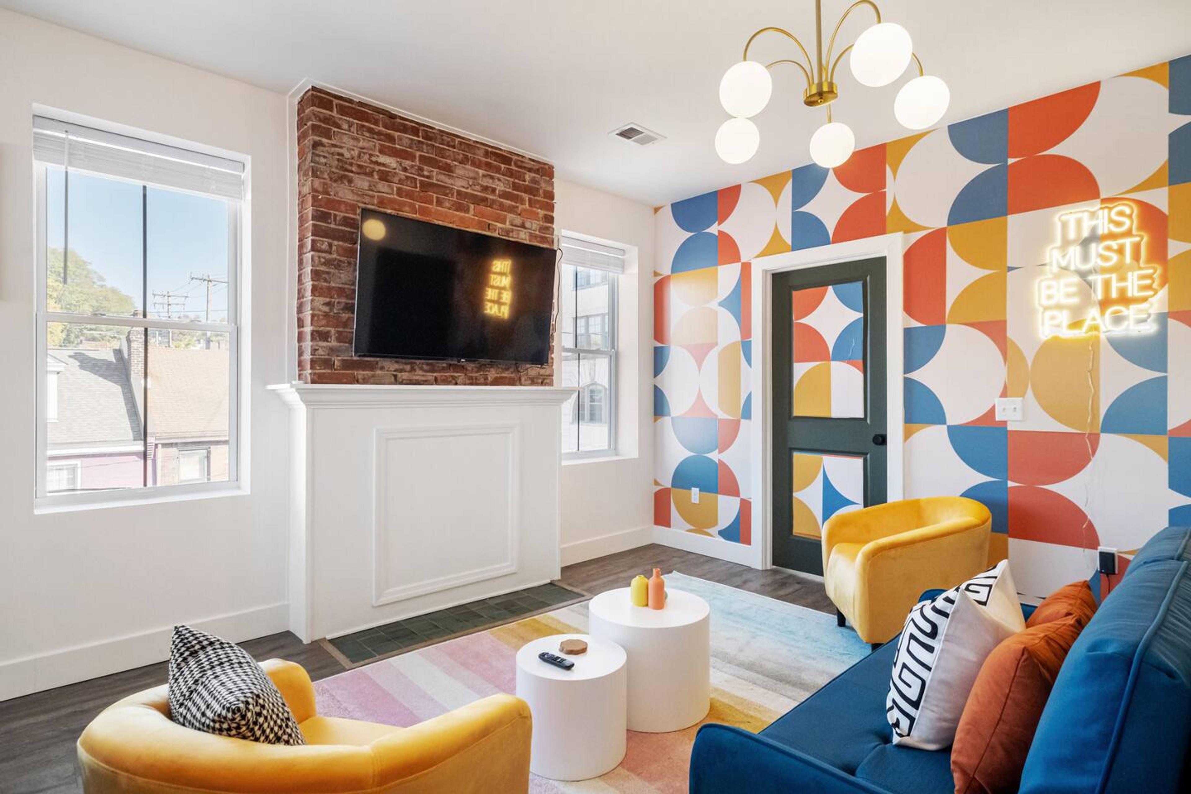 Living area : Find Comfort, Convenience, and Immersive Viewing in this lively Living Area with Center Table,  50 inch TV and a Brand New Cozy Couch
