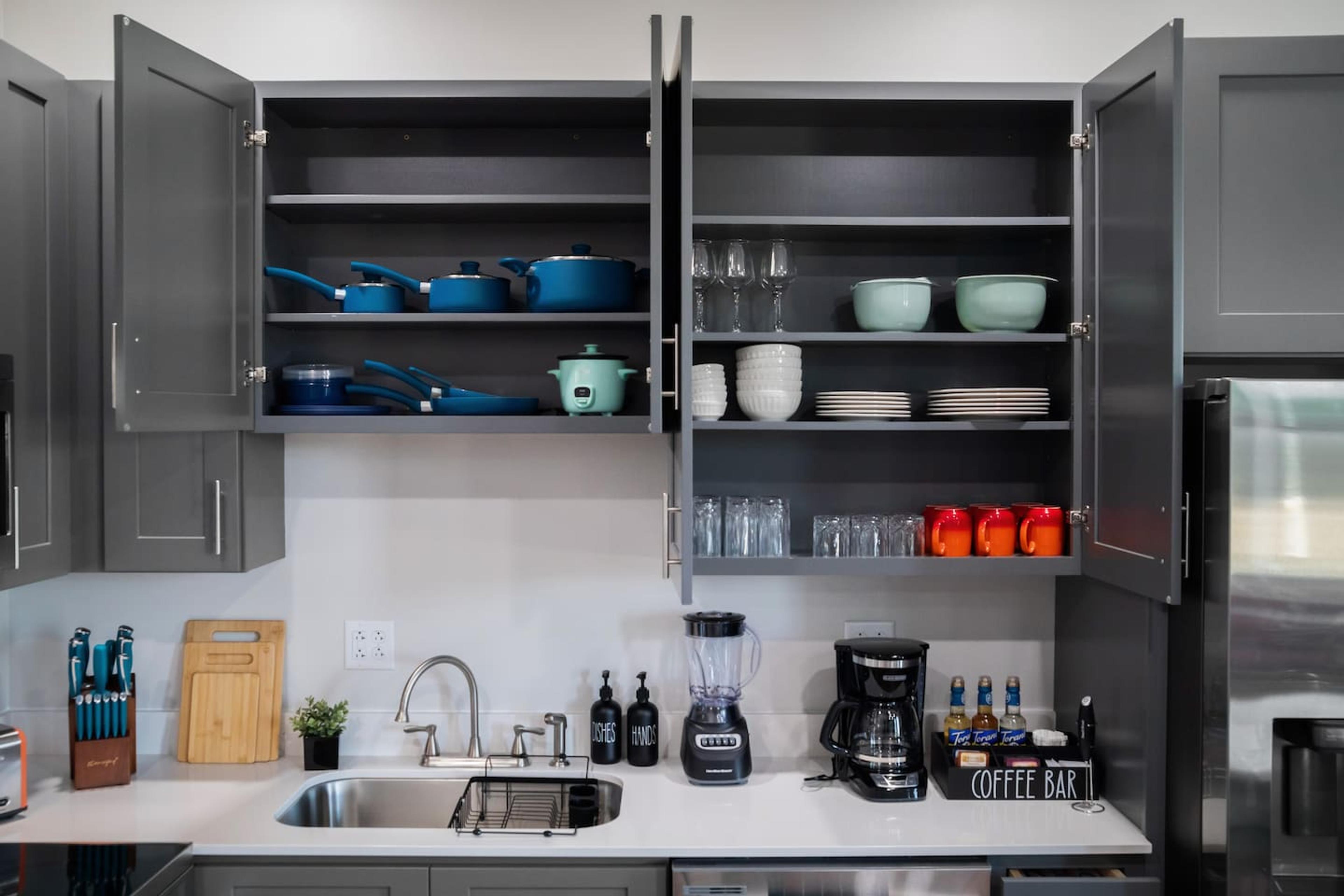 Kitchen with : Knife set , cutting board, hand & dish soap, blender, coffee station with coffee and tea flavours, pots , pans, cups, mugs, glasses  and dinning set !