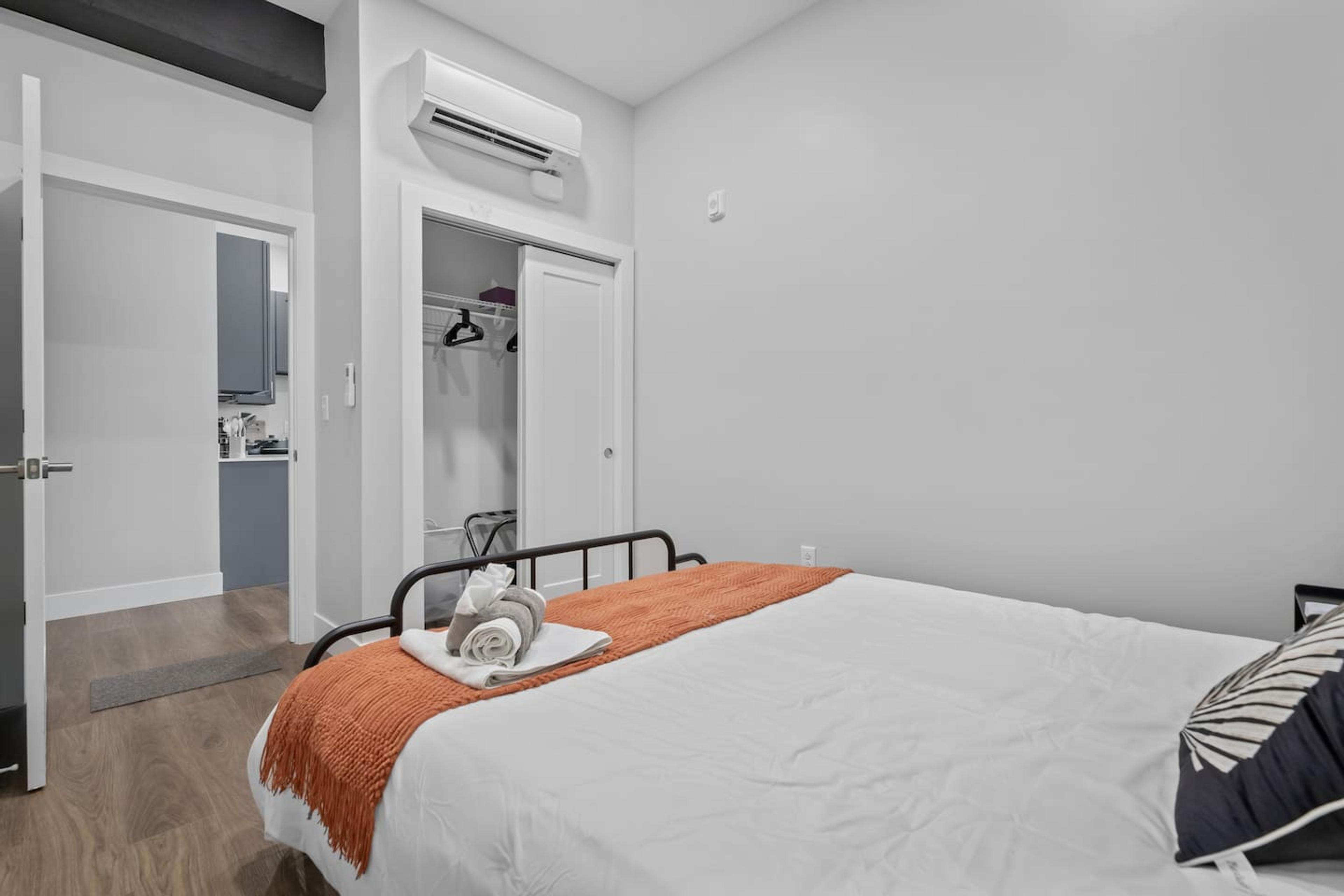 Picture of bedroom 1 with our clean bed and a closet space with ac amenity.