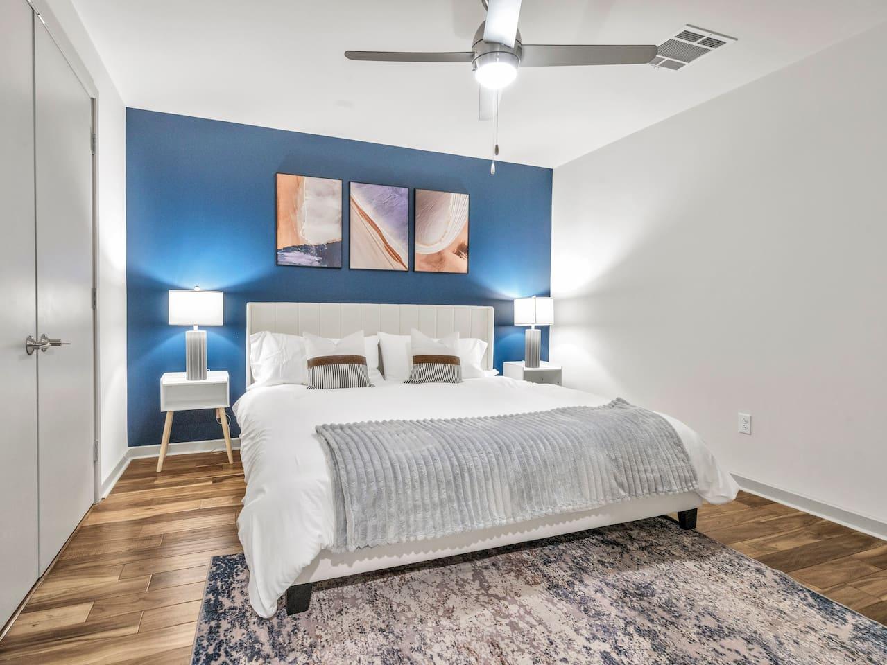 A Perfect cute spacious bedroom with one king bed that sleeps 2 adults. Designed with with comfort in mind and equipped with memory foam mattress, Cozy bedroom with nightstands, Pack N Play