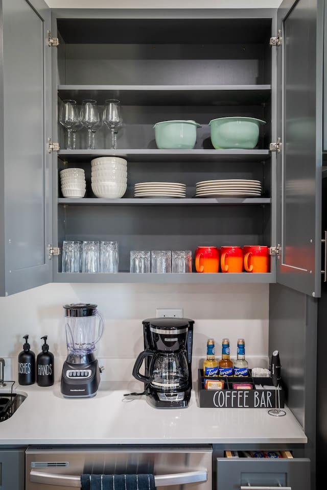Fully Stocked Kitchen with : Wine glass, cups, bows, glasses, mugs and coffee station on the lower right. Also had bender , rice cooker and many pots for families to enjoy cooking during the stay.