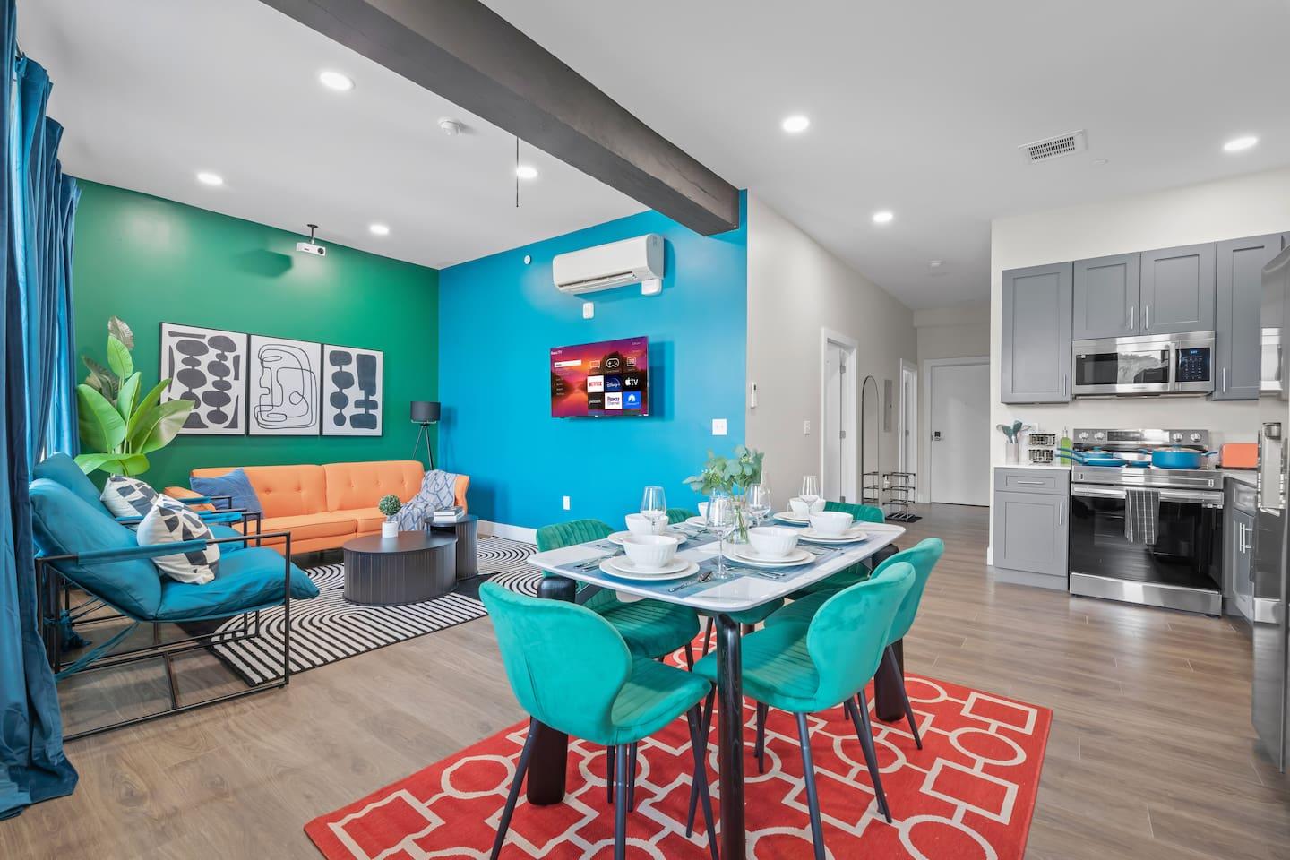 Living room area with a view of dining hall and kitchen
