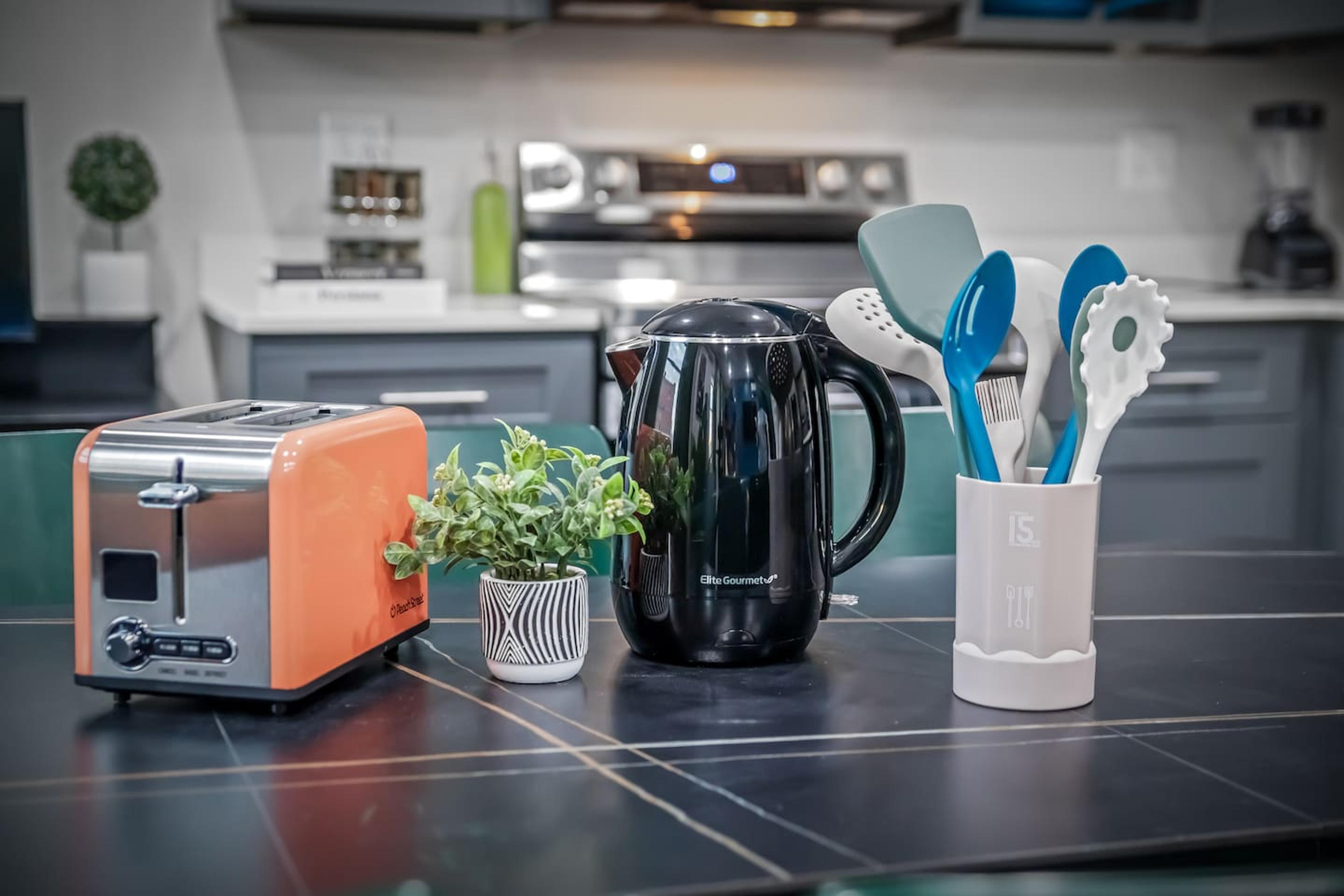 kitchen with a toaster, spatulas, ladles and kettle