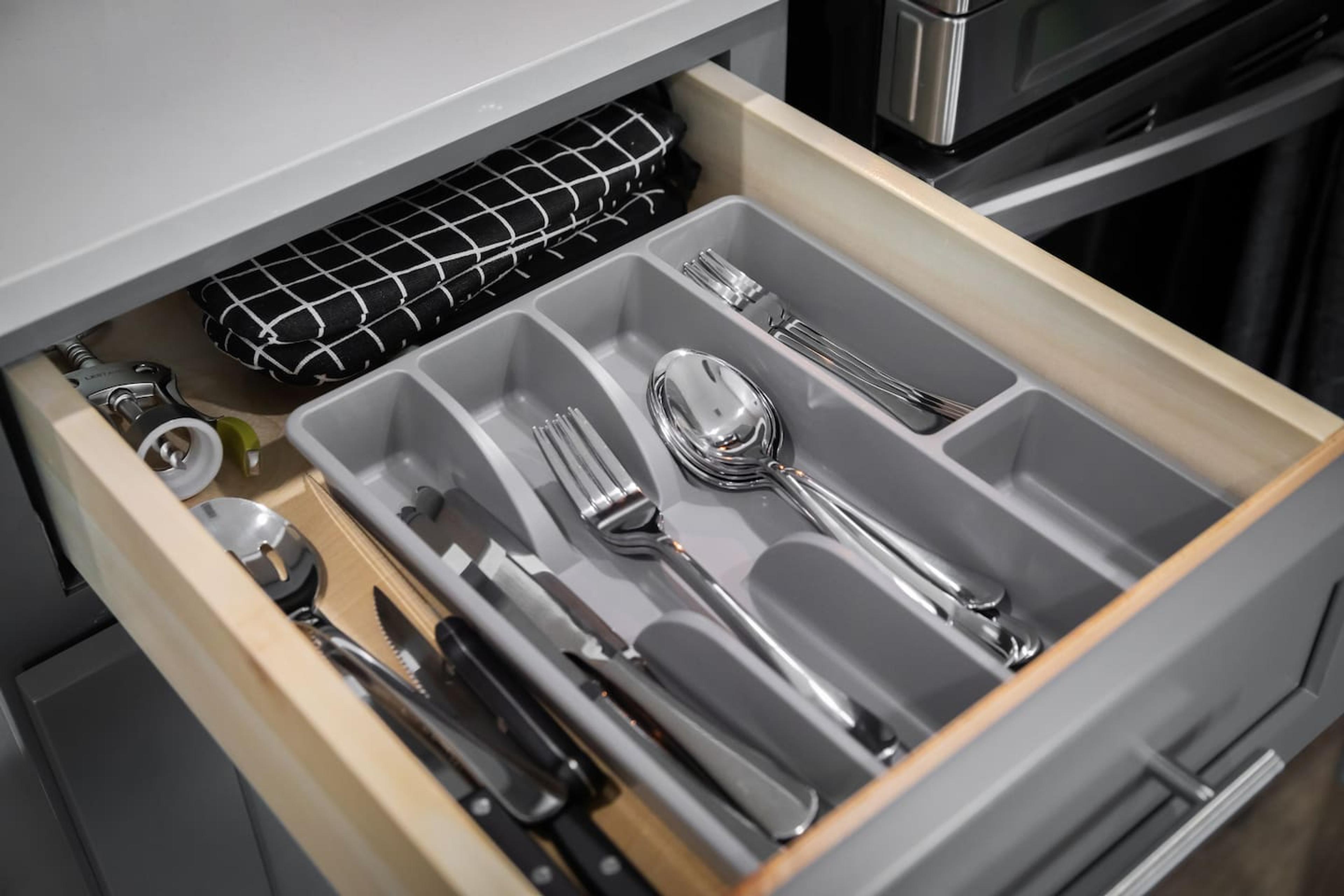 Spoons , fork, knife, mittens, wine opener etc on the left side of the stove.