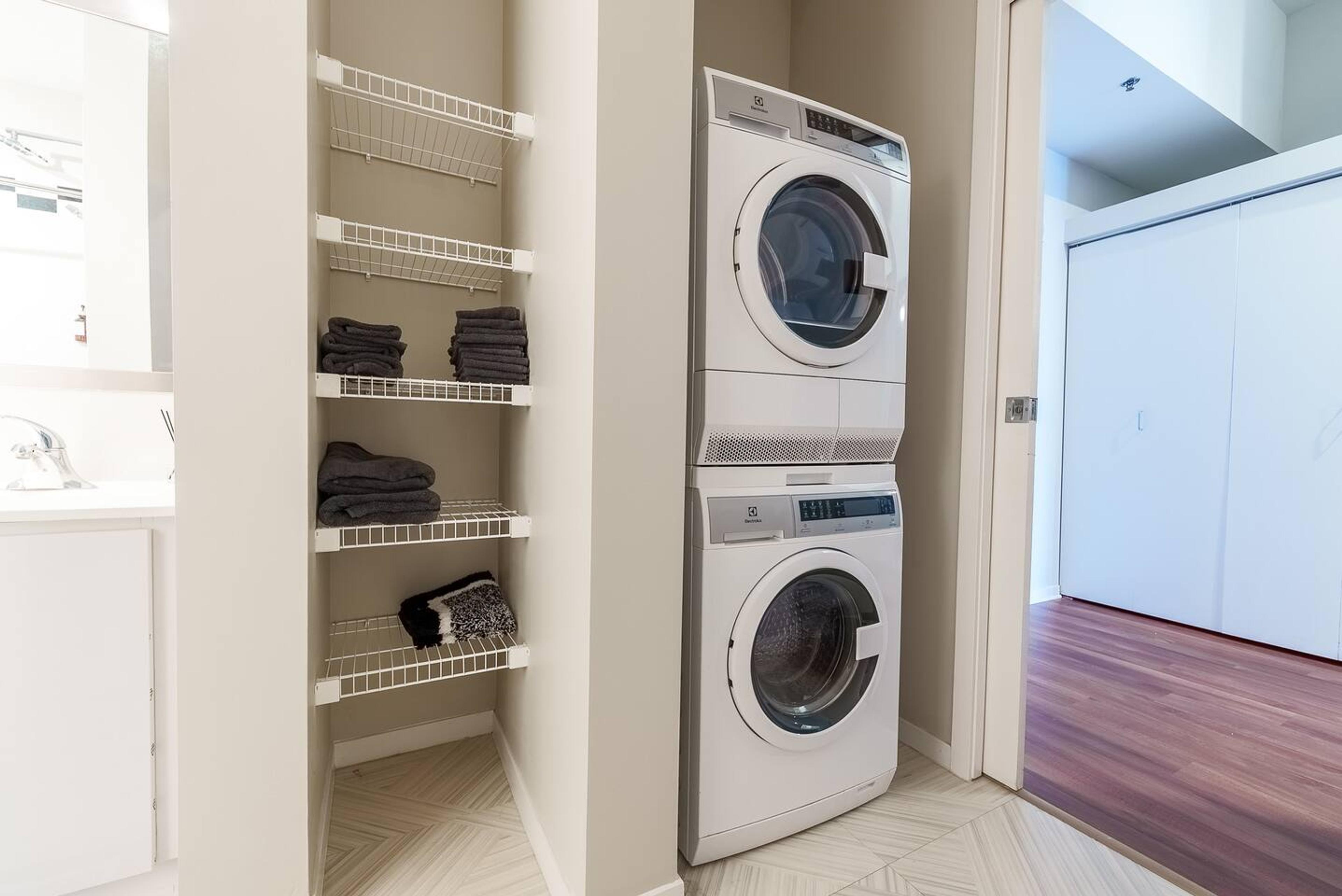 Convenient laundry area with full-size washer and dryer.