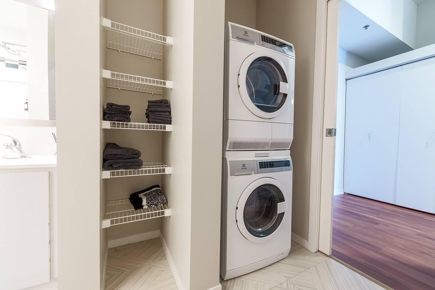 Convenient laundry area with full-size washer and dryer.